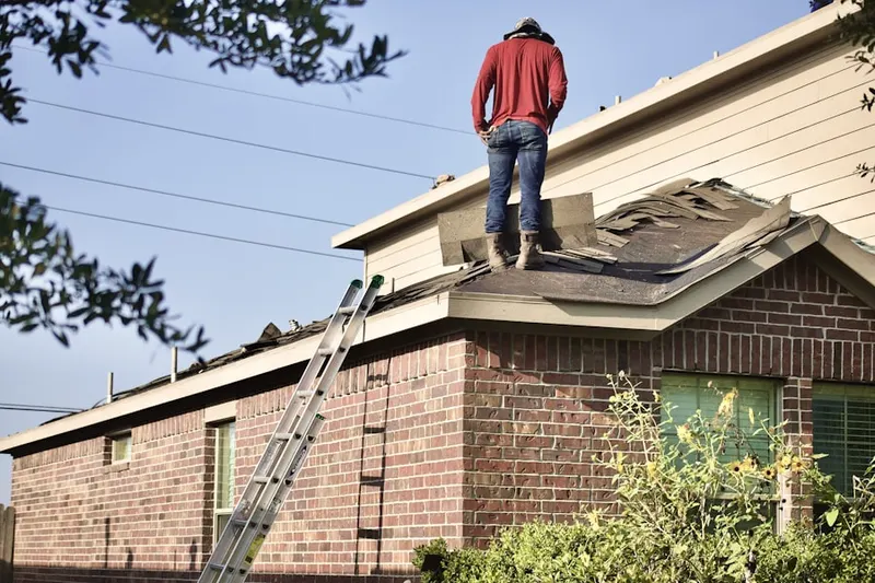 Professional roofer working on a residential roof in Kerns